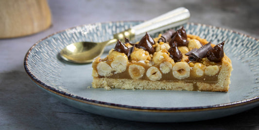 Vegan caramel and hazelnut tart gluten free and kosher for passover with dark chocolate ganache drops