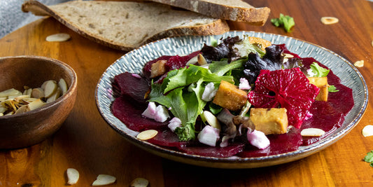 vegan roasted beet carpaccio in orange, balsamic vinegar , maple, tofu, almonds, salad